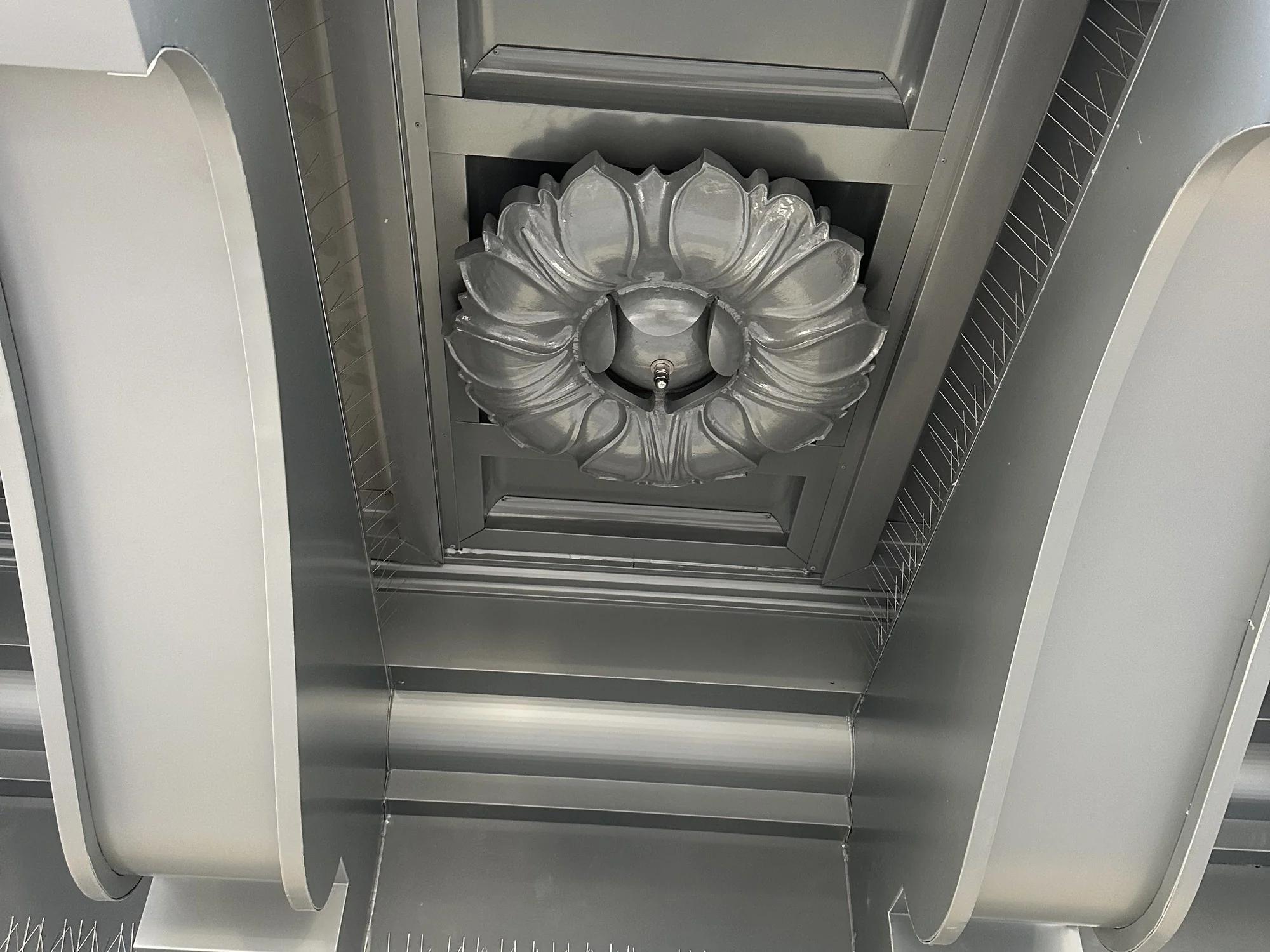 The underside of the cornice at close range: two modillion brackets with a rosette in the panel between them