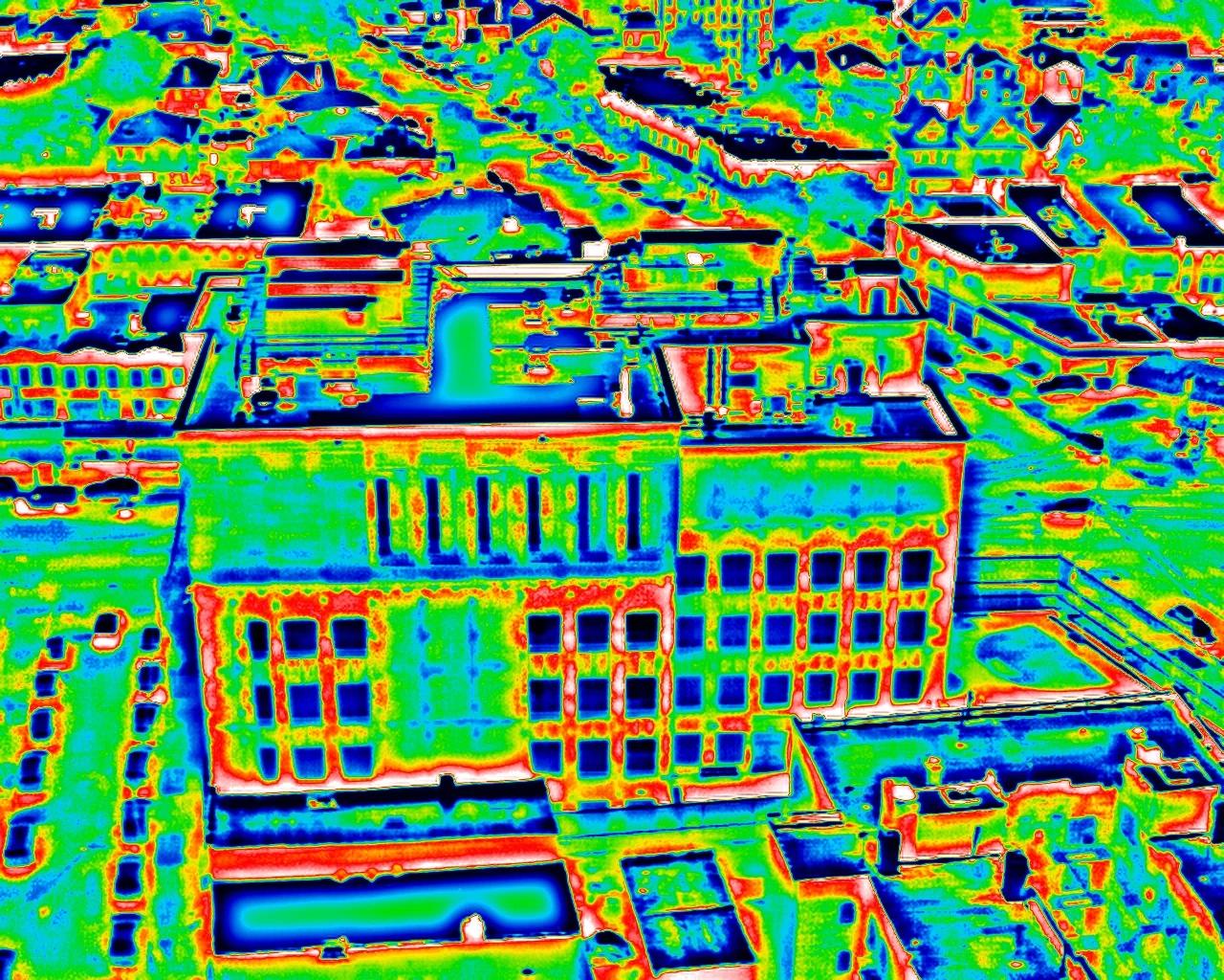 The same aerial thermal frame in the rainbow palette, temperatures mapped across blue, green, yellow and red