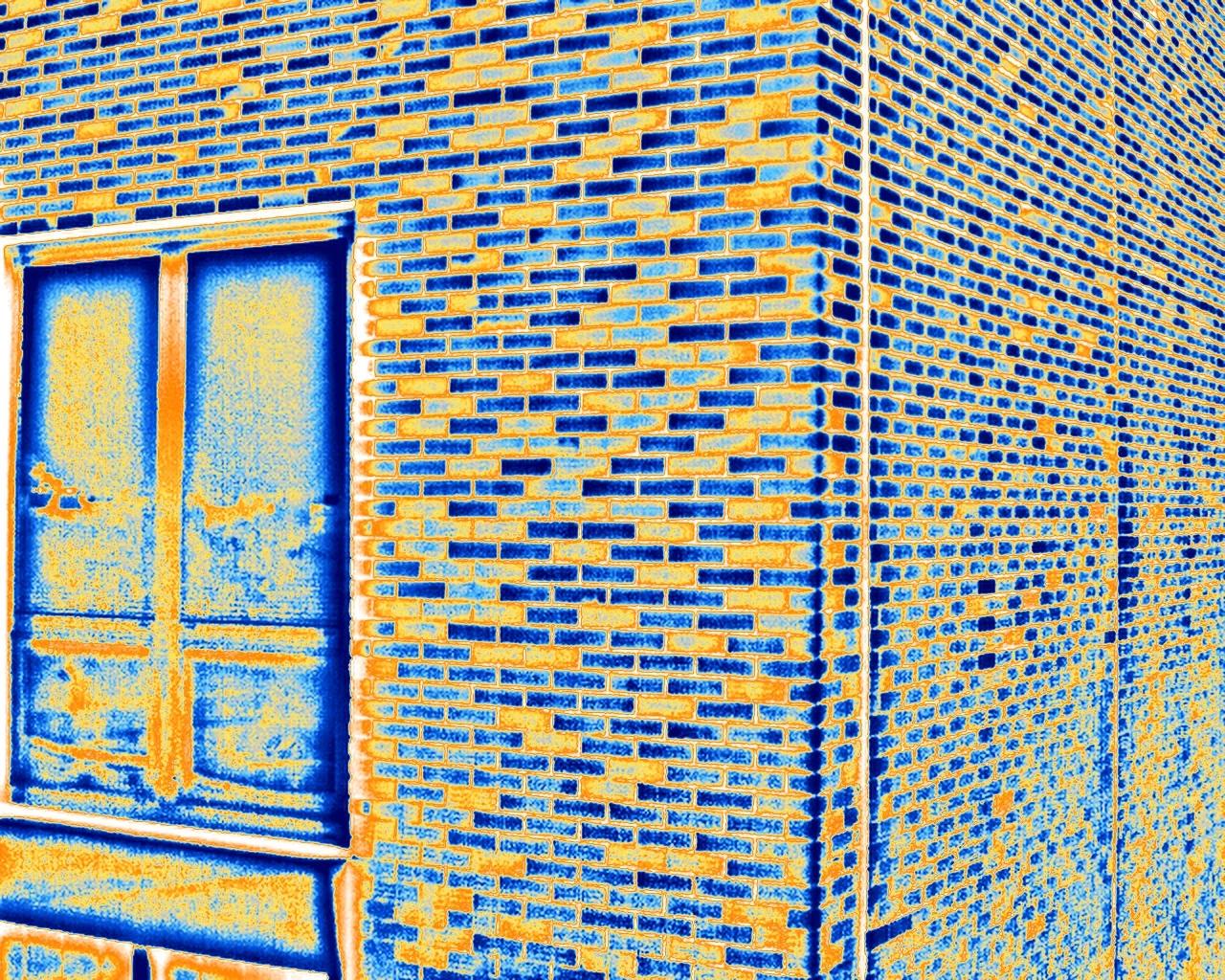 The same close-range frame in the arctic palette, the window and cooler bricks in blue, warmer bricks in orange and yellow