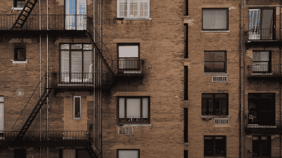 Brick façade with fire escapes, photographed square-on from the air